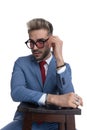 Sexy cool businessman arranging his sunglasses Royalty Free Stock Photo