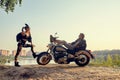 Sexy couple of bikers on the vintage custom motorcycle, girl in a rabbit mask Royalty Free Stock Photo