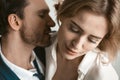 Sexy couple of business people in love. Close up portrait. Man going to kiss female neck. Selective focus on happy Royalty Free Stock Photo