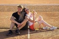 couple. Happy couple in love sit at tennis net on court Royalty Free Stock Photo