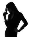 detective woman holding aiming gun silhouette Royalty Free Stock Photo