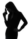 detective woman holding aiming gun silhouette Royalty Free Stock Photo