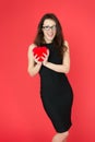 Sexy elegant woman hold red valentines day heart. formal woman in glasses. businesswoman in black dress. party Royalty Free Stock Photo