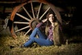 farm girl posing in front of rustic wagon in barn Royalty Free Stock Photo