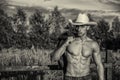 farmer or cowboy next to hay field Royalty Free Stock Photo