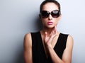 fashion female model in trendy sun glasses posing