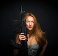 fashion glamour woman holding up her weapon assault rifle g Royalty Free Stock Photo