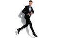 Sexy fashion model jumping and closing his tux