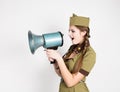 fashionable woman in military uniform and garrison cap, holding bullhorn and screaming Royalty Free Stock Photo