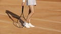 female athlete legs, woman wearing sportswear waiting for couch at court