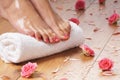 female feet, a white towel and petals on the floor Royalty Free Stock Photo