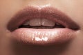 female lips with beige shiny gloss make-up