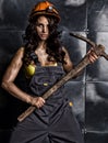 female miner worker with pickaxe, in coveralls over his naked body Royalty Free Stock Photo