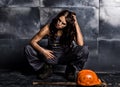 female miner worker with pickaxe, in coveralls over his naked body. erotic industry concept Royalty Free Stock Photo