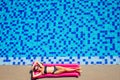 Sexy female model have a rest and sunbath on a float in the pool, top view aerial shot.woman in a black bikini swimsuit