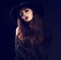 female model posing in black shirt and elegant hat with red Royalty Free Stock Photo