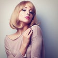 female model posing with blond short hair style. Color tone