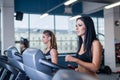 fit women running on treadmills in modern gym. Healthy young young girls doing running exercise on treadmill in gym. Royalty Free Stock Photo