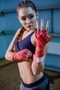 fitness blonde girl in sport wear. Portrait of female boxer in sport wear with fighting stance against spotlight. Royalty Free Stock Photo