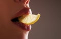 Sexy fruit. Closeup lips with lemons. Lemon slice in mouth. Summer refreshment concept. Tea time.