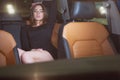 Sexy girl in the back seat of a prestigious car Royalty Free Stock Photo