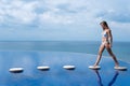 Sexy girl. beautiful woman. model lady bikini underwear sit edge of water swim pool on the roof of luxury resort hotel Royalty Free Stock Photo