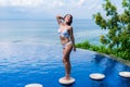Sexy girl. beautiful woman. model lady bikini underwear sit edge of water swim pool on the roof of luxury resort hotel Royalty Free Stock Photo