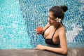 Sexy girl with big boobs drink juice in swimming pool Royalty Free Stock Photo