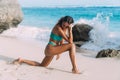 girl in blue swimsuit posing on sunny day on sandy beach Royalty Free Stock Photo