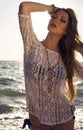 girl with dark hair in bikini posing on sunset beach Royalty Free Stock Photo