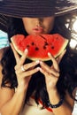 girl with dark hair eating watermelon Royalty Free Stock Photo