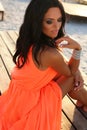 girl with dark hair in elegant dress relaxing on beach Royalty Free Stock Photo