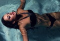 girl with dark hair posing at swimming pool at night Royalty Free Stock Photo