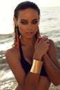 girl with dark hair and tanned skin posing on beach Royalty Free Stock Photo