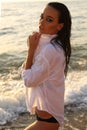 girl with dark hair and tanned skin posing on beach Royalty Free Stock Photo