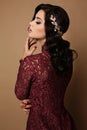 girl with dark hair wears elegant lace dress, luxurious necklace and tiara Royalty Free Stock Photo