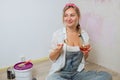 Sexy girl designer eats sushi on the construction site. painter has lunch after Royalty Free Stock Photo