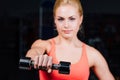 girl doing exercises in her arms biceps and triceps. fitness with dumbbells in the gym. Royalty Free Stock Photo