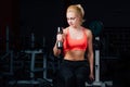 girl doing exercises in her arms biceps and triceps. fitness with dumbbells in the gym. Royalty Free Stock Photo