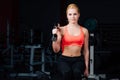 girl doing exercises in her arms biceps and triceps. fitness with dumbbells in the gym. Royalty Free Stock Photo