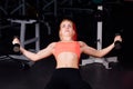 girl doing exercises in her pectoral muscle. fitness with dumbbells in the gym. nice cute female. Royalty Free Stock Photo