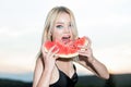 Sexy girl eating a watermelon. Fashion glamor portrait of beautiful sexy stylish blonde young woman model with bright Royalty Free Stock Photo