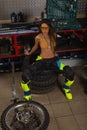 Sexy girl in garage with bike tires Royalty Free Stock Photo