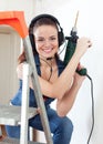 girl in headphones with drill Royalty Free Stock Photo