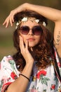 girl hippie in sunglasses looking at the camera and holding hands face Outdoors Royalty Free Stock Photo