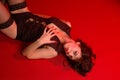 girl laying on red background