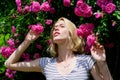 Sexy girl on pink rose background. natural beauty. Spa and skincare. summer and spring park nature. rose flower smell