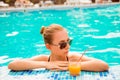 Sexy girl in a pool with juice and glasses Royalty Free Stock Photo