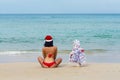 girl Santa in bikini on a beach fir-tree Royalty Free Stock Photo