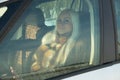 girl sitting behind the wheel of a car